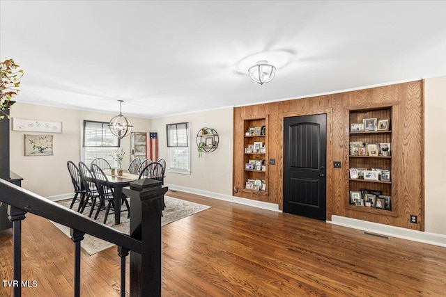 foyer featuring hardwood / wood-style floors and a chandelier