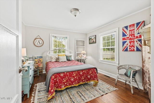 bedroom with crown molding and dark hardwood / wood-style floors