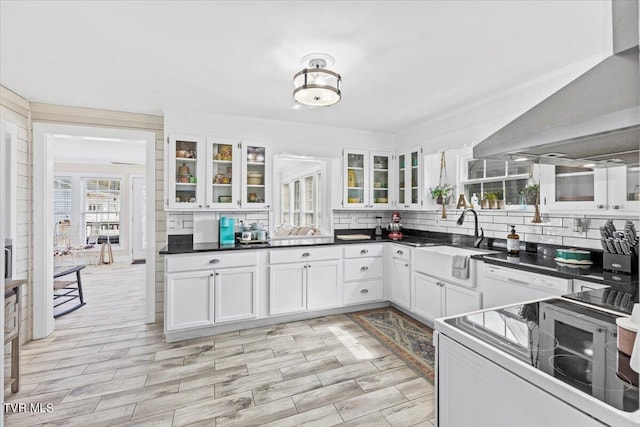 kitchen with white cabinets, light wood-type flooring, white electric range, range hood, and sink