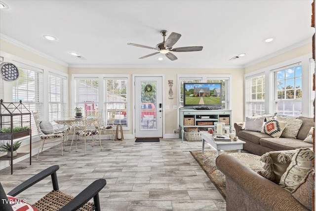 living room with light wood-type flooring, ceiling fan, and crown molding