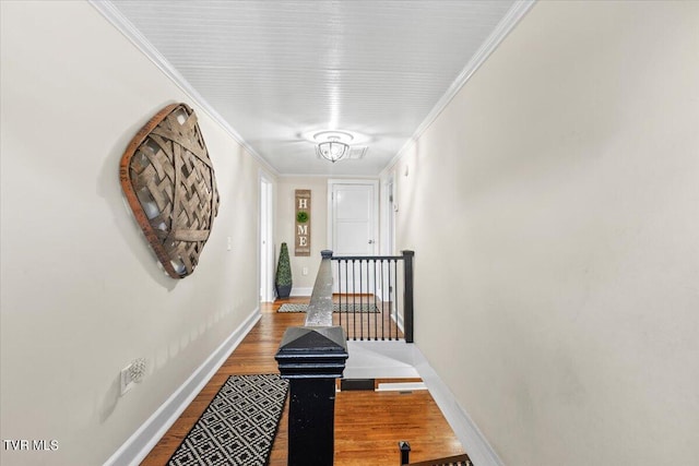 corridor with hardwood / wood-style floors and crown molding