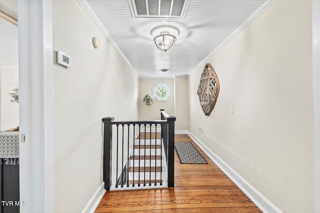 corridor with crown molding and hardwood / wood-style floors