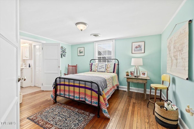 bedroom featuring wood-type flooring and crown molding