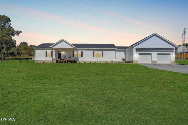 ranch-style house with a lawn and a garage