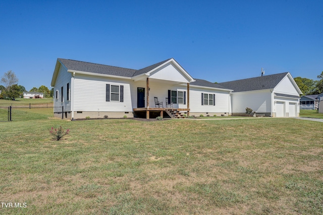 view of front facade with a front yard, a garage, and a deck