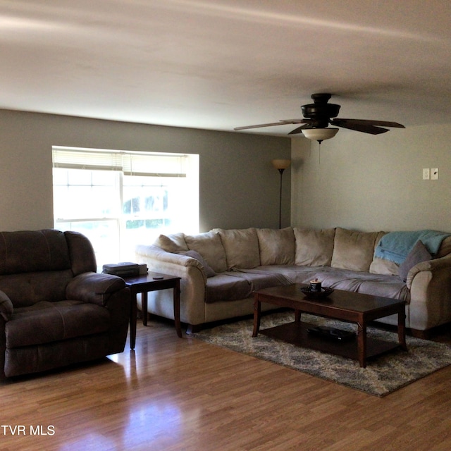 living room featuring hardwood / wood-style flooring and ceiling fan