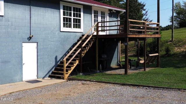 back of property featuring a lawn and a deck