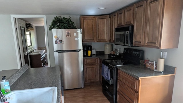 kitchen featuring hardwood / wood-style floors, sink, and appliances with stainless steel finishes