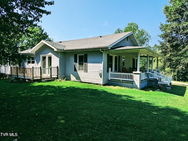 view of home's exterior with covered porch and a yard