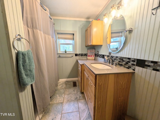 bathroom featuring radiator, vanity, and crown molding