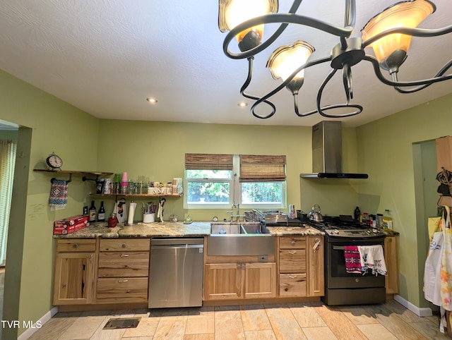 kitchen featuring a chandelier, dishwasher, gas stove, sink, and wall chimney range hood