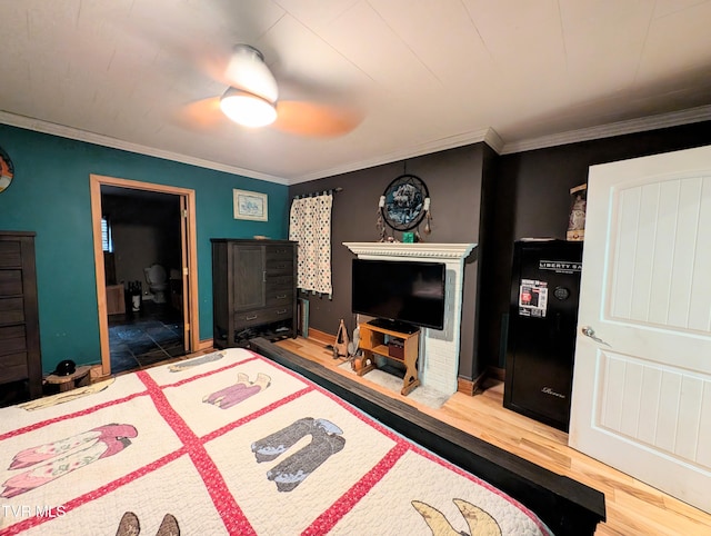 bedroom featuring wood-type flooring, crown molding, and ceiling fan