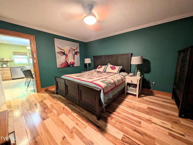 bedroom featuring light wood-type flooring, ceiling fan, and crown molding