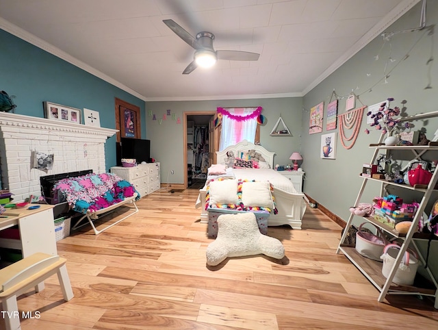 bedroom featuring ceiling fan, hardwood / wood-style flooring, and crown molding