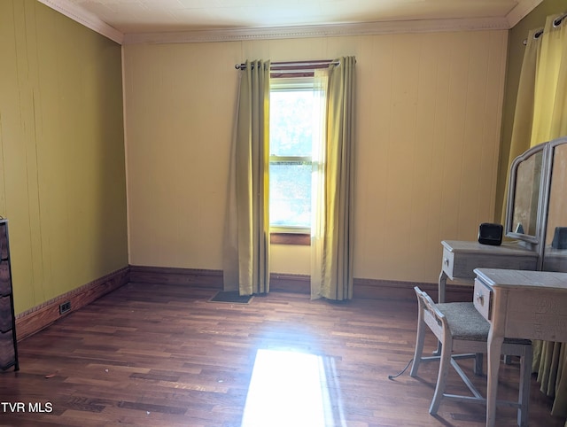 interior space with crown molding, wood walls, and dark wood-type flooring