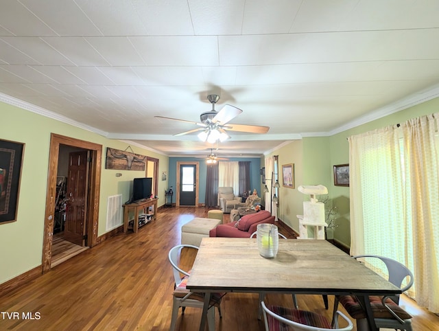 dining area featuring ceiling fan, hardwood / wood-style flooring, and ornamental molding