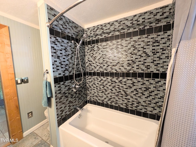 bathroom featuring a textured ceiling, tiled shower / bath combo, and toilet