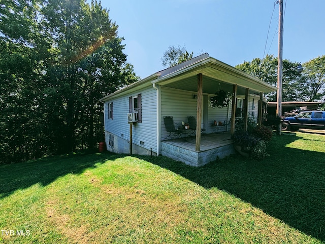 view of home's exterior with cooling unit and a yard