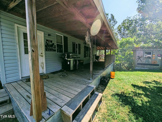 deck with a yard and area for grilling