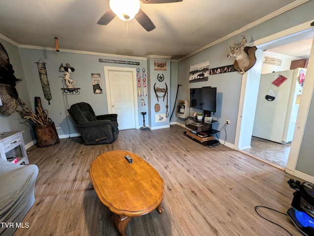 living room with ceiling fan, ornamental molding, and wood-type flooring