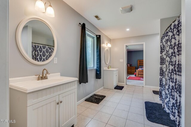 bathroom featuring tile patterned flooring and vanity