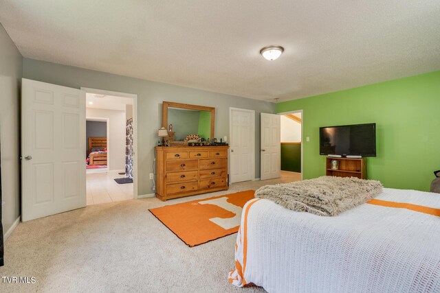 bedroom with a textured ceiling and light colored carpet