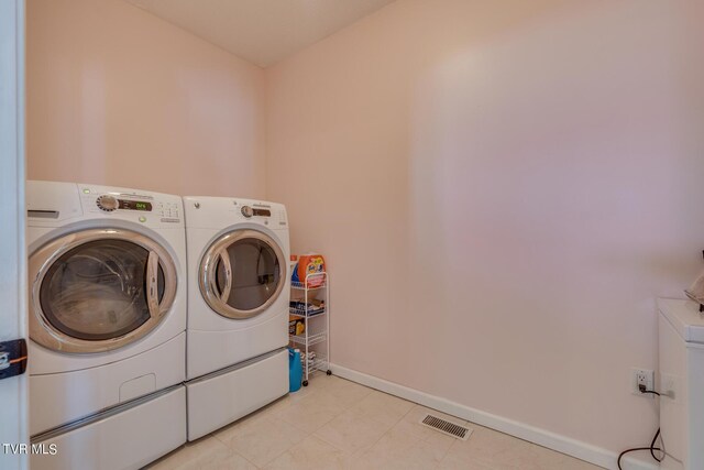 clothes washing area featuring washer and clothes dryer