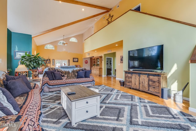 living room with high vaulted ceiling, light wood-type flooring, and beam ceiling