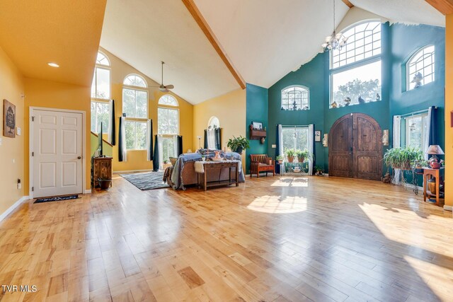 foyer entrance featuring a healthy amount of sunlight, light hardwood / wood-style flooring, and high vaulted ceiling