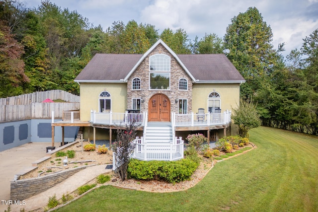 view of front of property with a front yard, a deck, and french doors