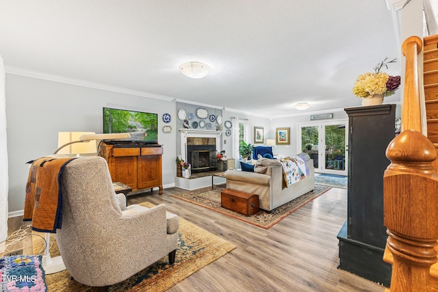 376 Cain Dr, Blountville, TN 37617 - living room featuring baseboards, wood finished floors, a tiled fireplace, and crown molding