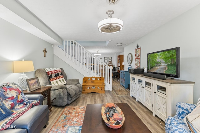 376 Cain Dr, Blountville, TN 37617 - living room featuring light wood-type flooring, stairway, and a textured ceiling