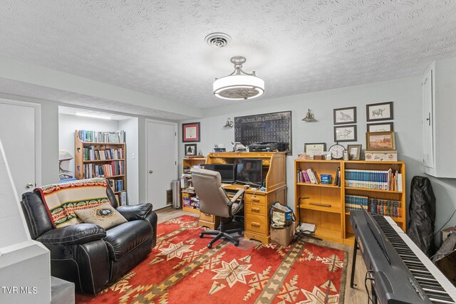 office area featuring a textured ceiling and hardwood / wood-style flooring