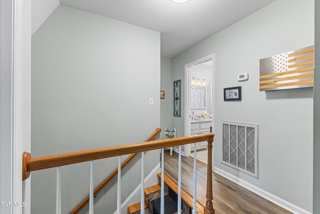 376 Cain Dr, Blountville, TN 37617 - stairs featuring baseboards, visible vents, wood finished floors, and a textured ceiling