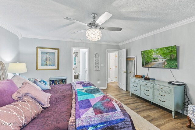 376 Cain Dr, Blountville, TN 37617 - bedroom featuring connected bathroom, ornamental molding, a textured ceiling, and wood finished floors