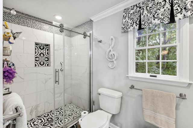 bathroom featuring crown molding, an enclosed shower, and toilet