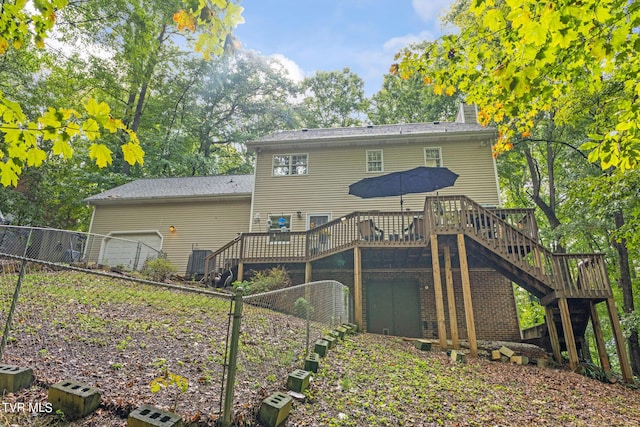 376 Cain Dr, Blountville, TN 37617 - back of property featuring a garage, a deck, stairway, and fence
