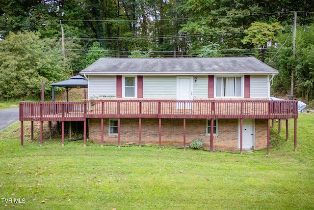 back of house featuring a gazebo, a yard, and a wooden deck