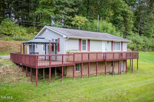 back of property with a gazebo, a deck, and a yard