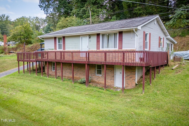 back of house featuring a lawn and a wooden deck