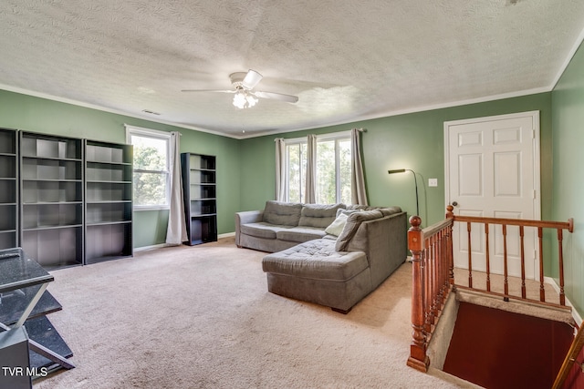 living room with ceiling fan, light colored carpet, a textured ceiling, and plenty of natural light