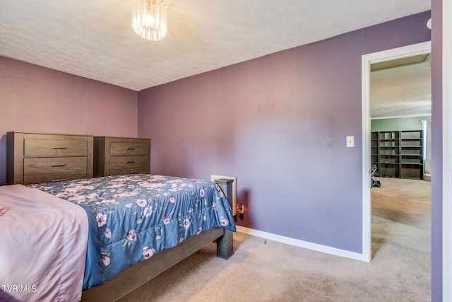 carpeted bedroom featuring a textured ceiling