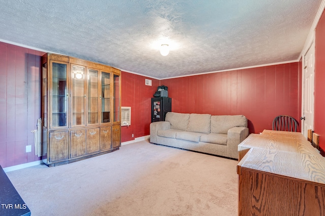 carpeted living room with a textured ceiling, ornamental molding, wood walls, and heating unit