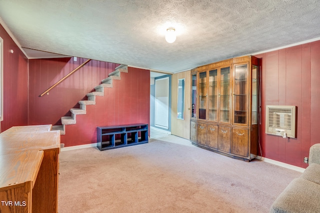 unfurnished living room featuring light carpet, heating unit, and a textured ceiling