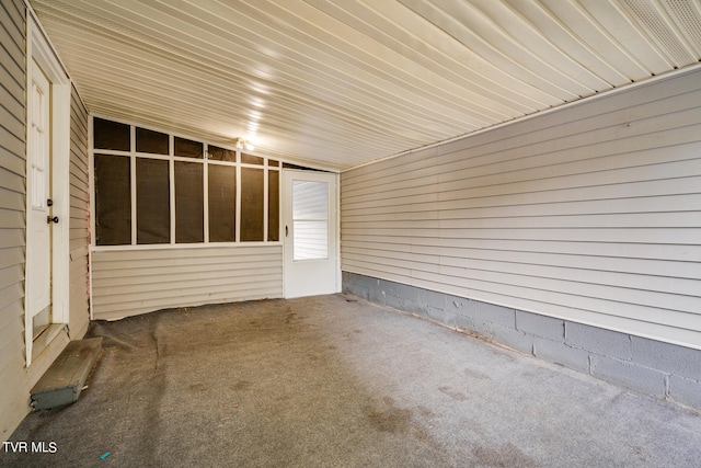 interior space with carpet and vaulted ceiling