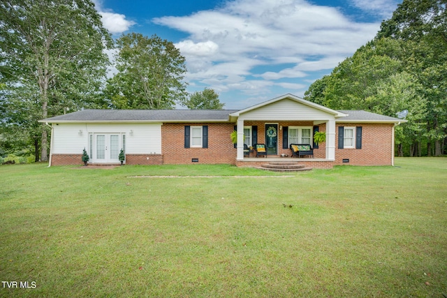 view of front of home with french doors, a porch, and a front lawn