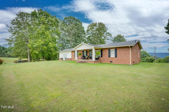 back of property with a lawn