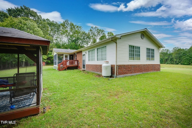 view of home's exterior featuring a lawn and a deck