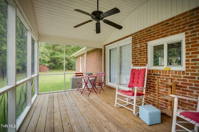 unfurnished sunroom with vaulted ceiling, ceiling fan, and plenty of natural light