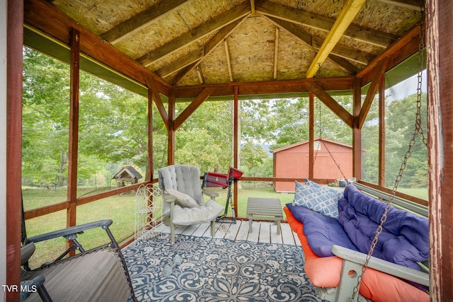 sunroom featuring vaulted ceiling